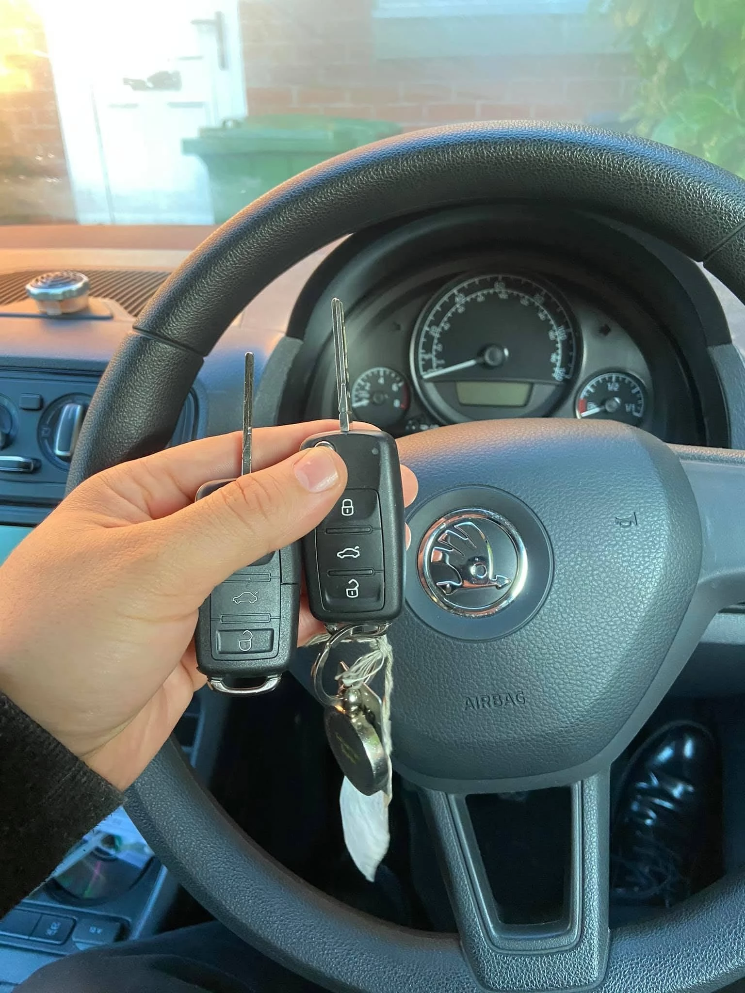 Two Skoda Citigo remote car keys photographed inside the vehicle during a spare key job in Cheltenham